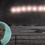 Nighttime field with a fence and bright stadium lights; a circular inset shows an older man in a plaid shirt in the lower-left corner.