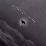 Drone/aircraft targeting view showing crosshair over a dark silhouette in a doorway-like box; a small target is identified in the center.