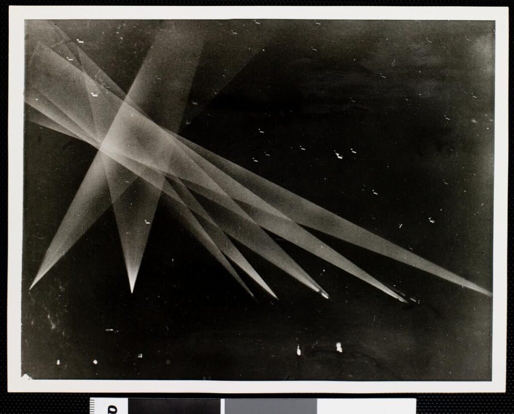 EXM-P-S-LOS-ANG-CIT-WW2-003~1 - UAPedia Abstract black-and-white photo of translucent overlapping triangles forming sharp rays on a dark background.